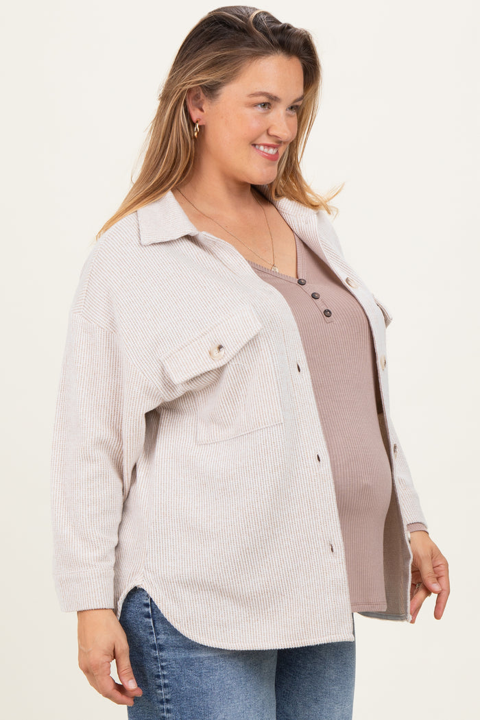 woman wearing a beige ribbed button-up shirt over a brown maternity tank top, showing her baby bump