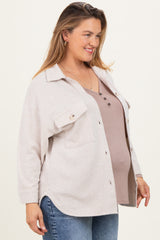 woman wearing a beige ribbed button-up shirt over a brown maternity tank top, showing her baby bump
