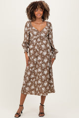 woman wearing a brown floral maternity dress with long sleeves and a v-neckline, showcasing a baby bump