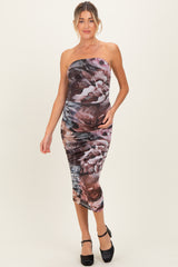 woman wearing a dark floral print strapless maternity dress with a fitted silhouette and side ruching, showing a baby bump