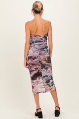 woman wearing a strapless multicolored maternity dress with a fitted silhouette and midi length, showing her baby bump