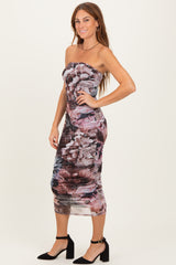 woman wearing a strapless floral print midi dress with ruched detailing and a fitted silhouette