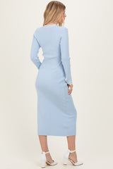 woman wearing a light blue ribbed long sleeve midi dress with white collar and back view, paired with white heels