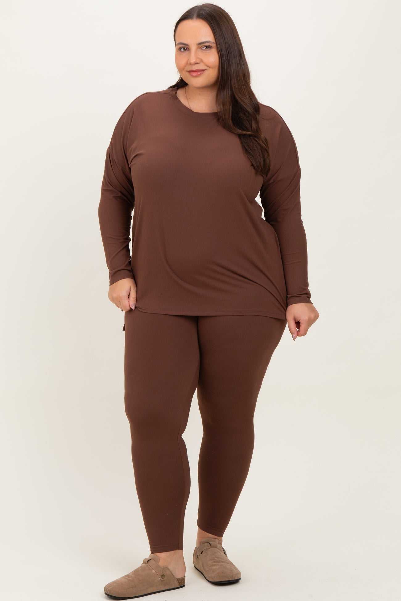 woman wearing a brown long sleeve top and matching leggings in plus size