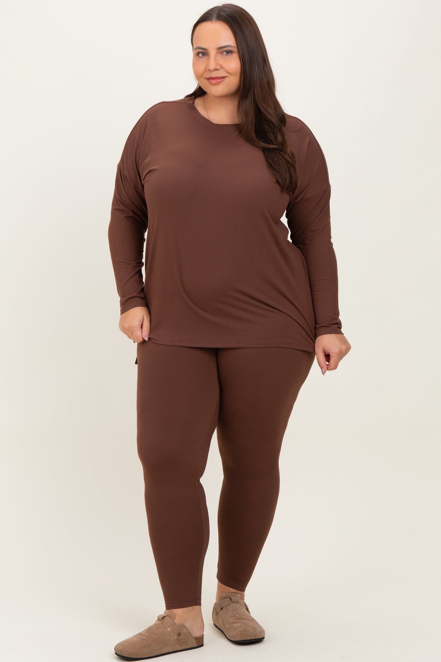 woman wearing a brown long sleeve top and matching leggings in plus size