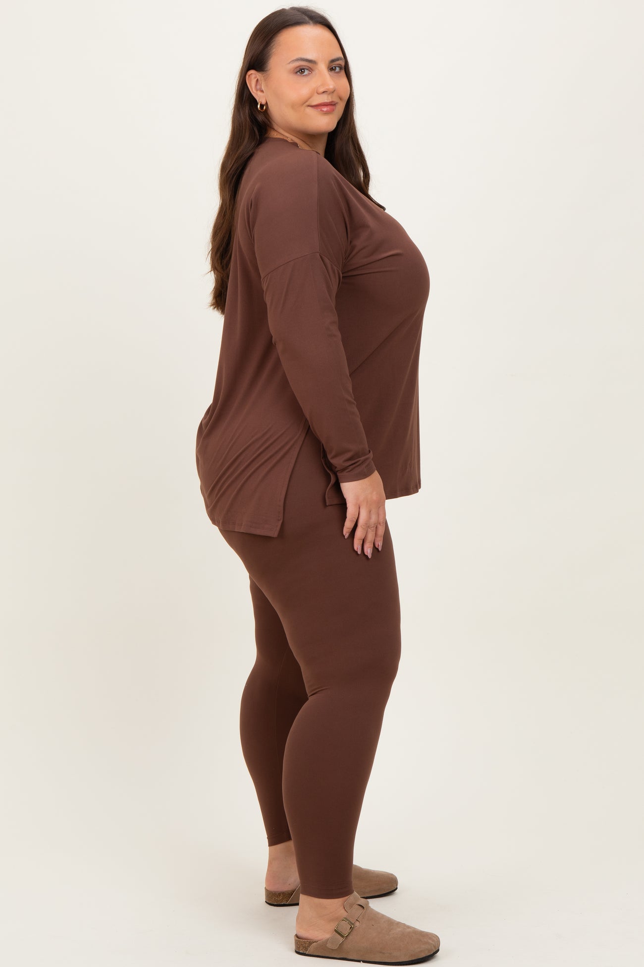 woman wearing a brown long sleeve top and matching leggings, styled for plus size fashion