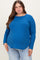 woman wearing a vibrant blue long sleeve maternity top with a curved hem and a visible baby bump