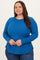 woman wearing a blue long sleeve plus size ribbed top with side slits and a relaxed fit