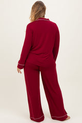 woman wearing a red maternity plus pajama set with long sleeves and wide-leg pants, viewed from the back