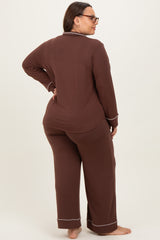 woman wearing a brown plus size pajama set with long sleeves and pants, shown from the back
