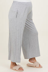 woman wearing gray maternity wide-leg pants with a comfortable waistband and a visible baby bump