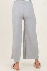 woman wearing light gray wide-leg maternity pants, shown from the back