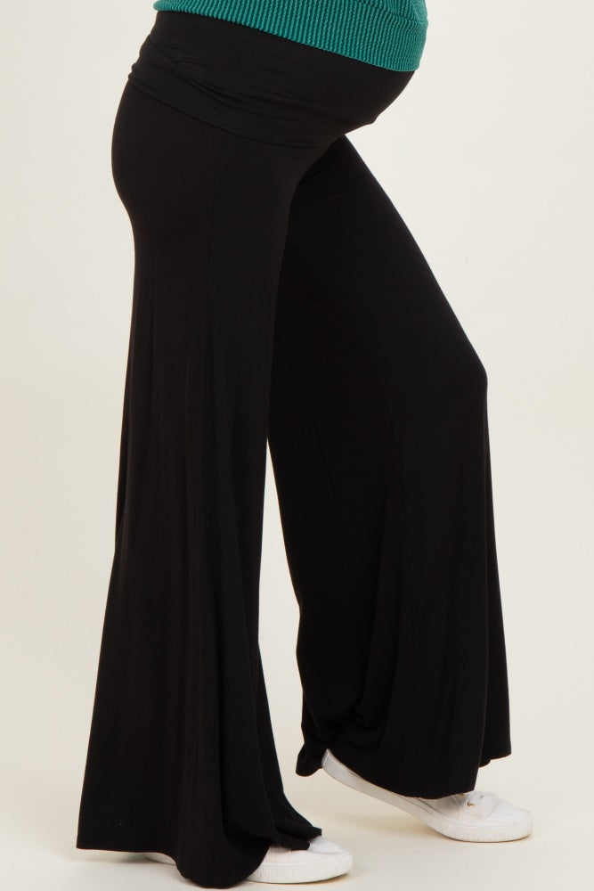woman wearing a black maternity pant with a flowing silhouette and a visible baby bump