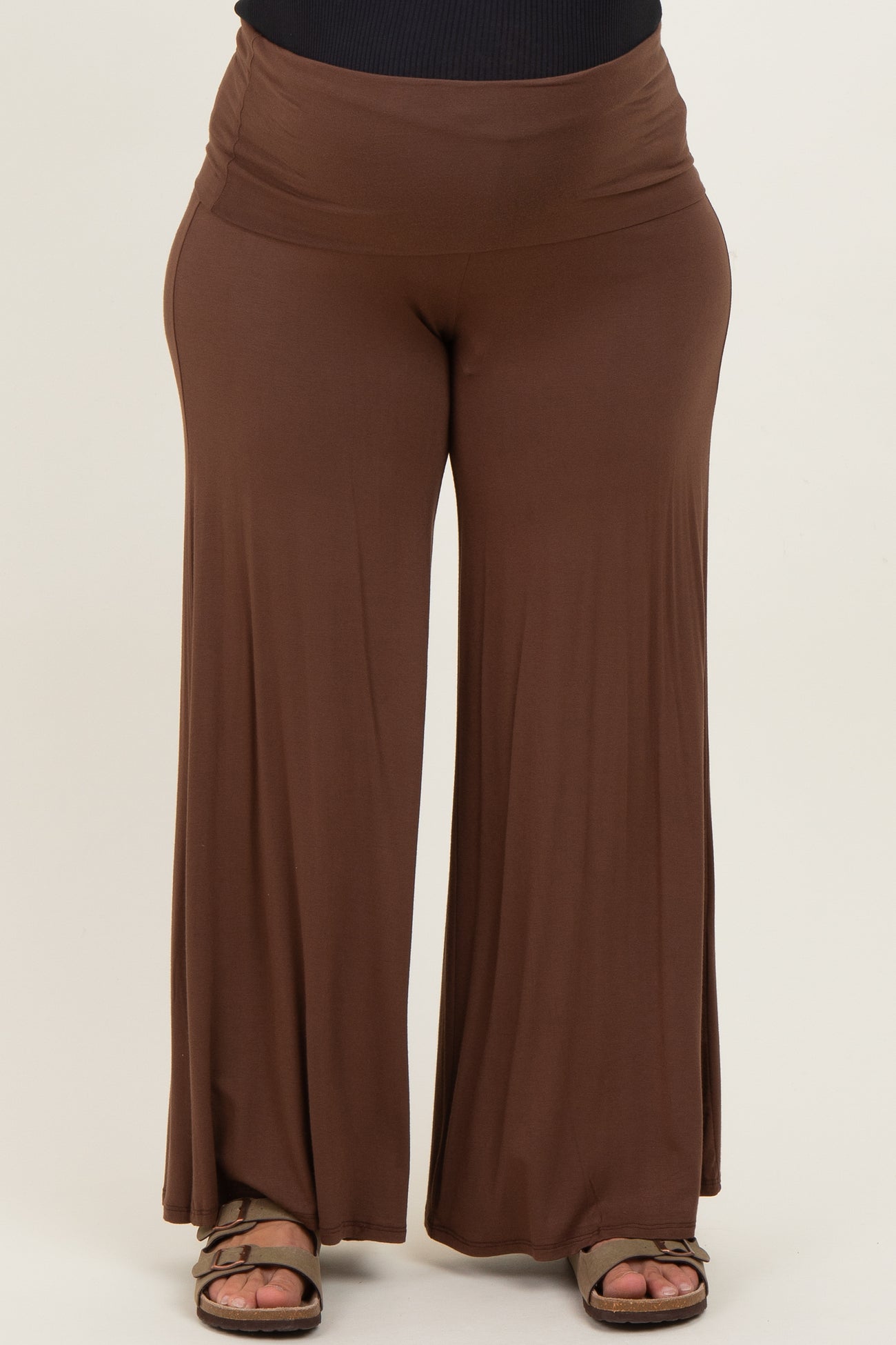 woman wearing a brown maternity plus wide-leg pants with a comfortable high waistband