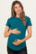 woman wearing a teal short sleeve maternity top and holding her baby bump