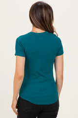 woman wearing a teal maternity t-shirt with short sleeves and a curved hem, viewed from the back