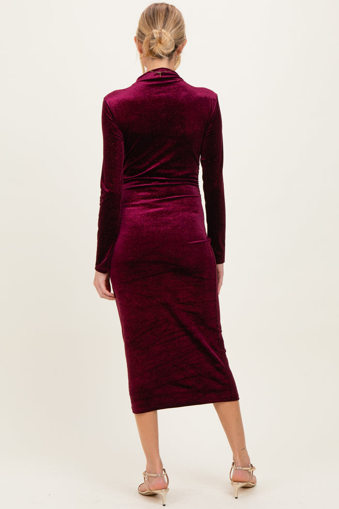 woman wearing a burgundy long sleeve maternity dress with a bodycon fit and mid-calf length