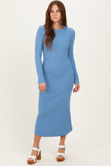 woman wearing a light blue ribbed long sleeve maxi dress and white heeled sandals