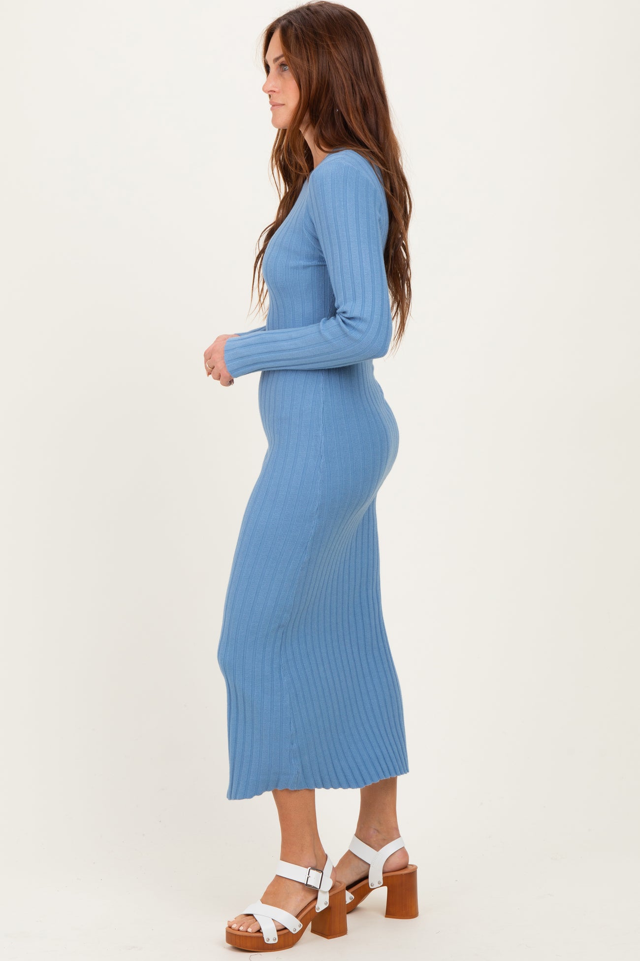 woman wearing a light blue ribbed long sleeve midi dress and chunky heeled sandals