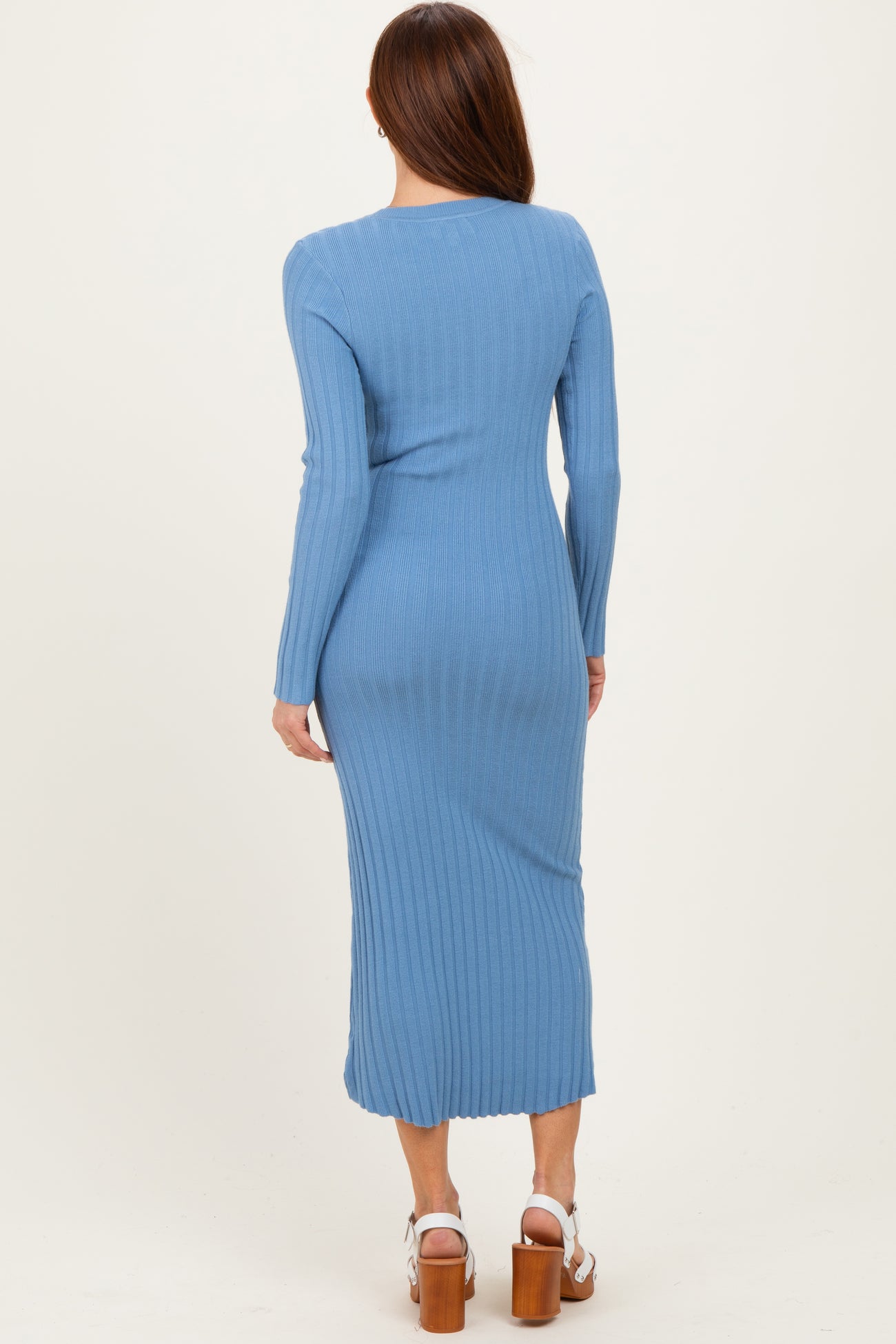 woman wearing a long sleeve ribbed midi dress in light blue, viewed from the back