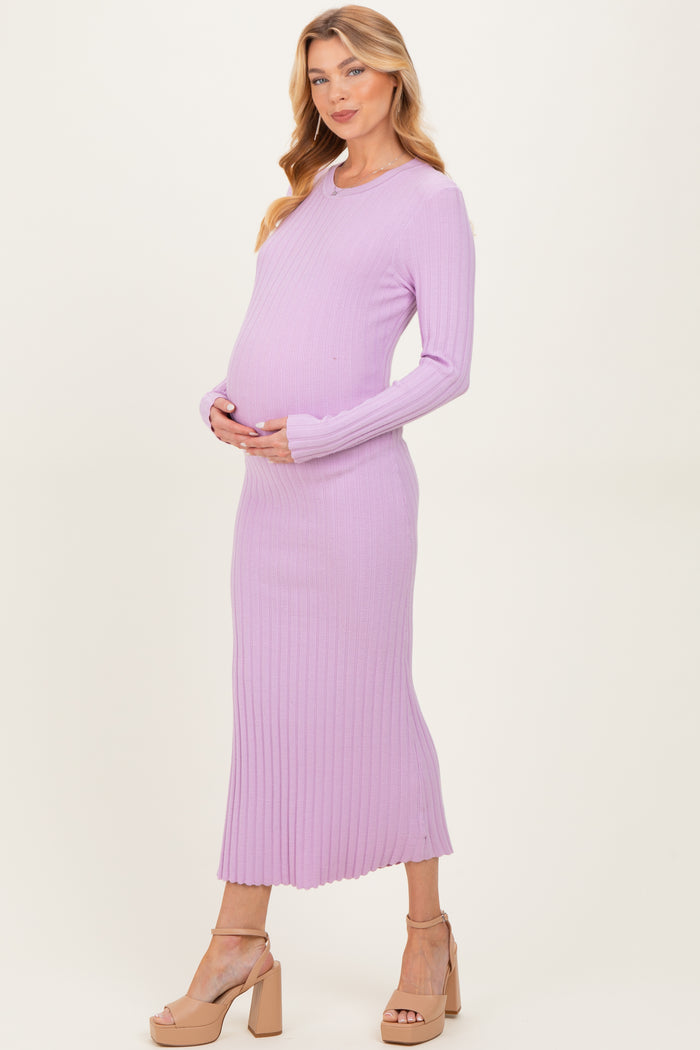 woman wearing a light purple ribbed maternity dress and holding her baby bump