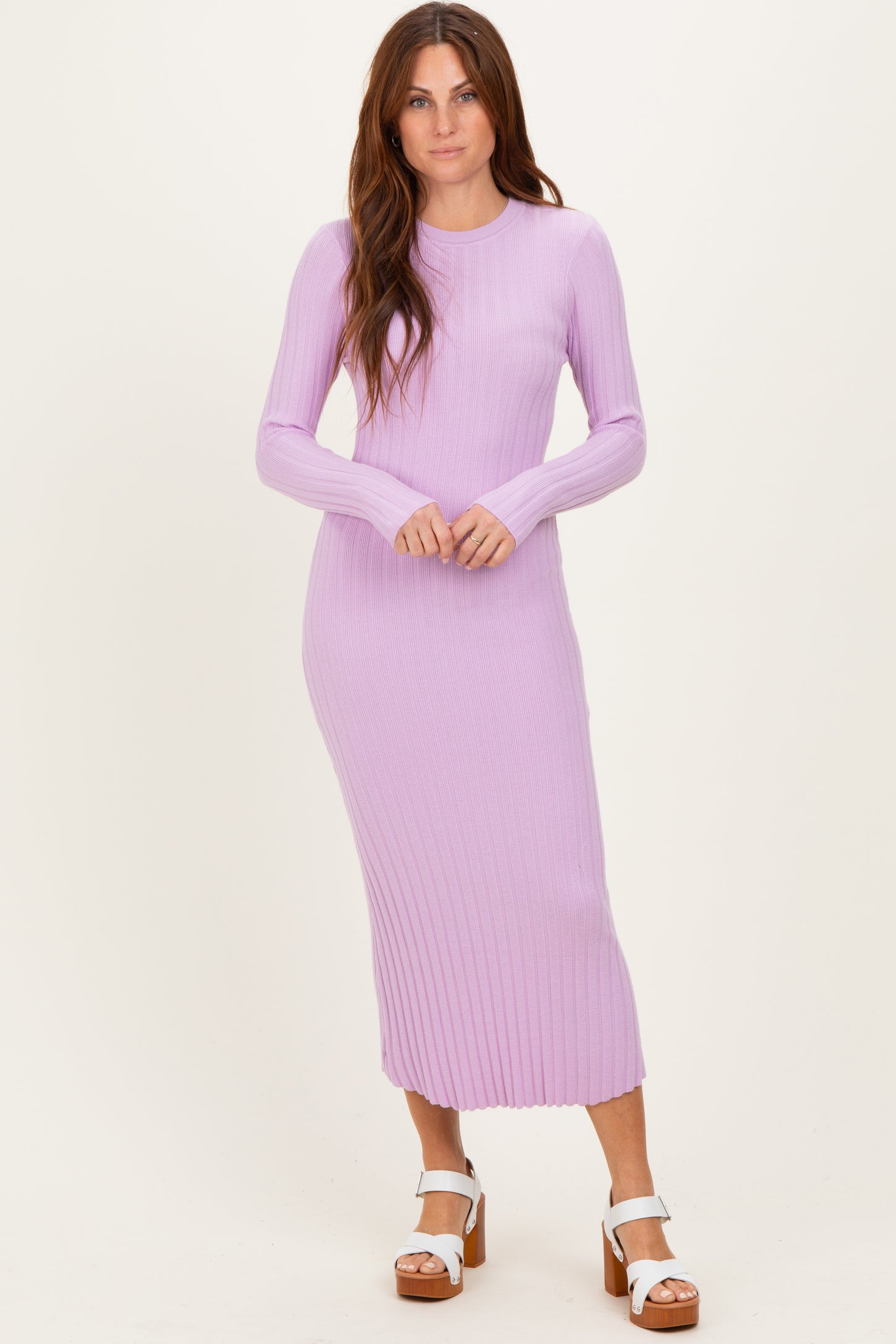 woman wearing a light purple ribbed long sleeve midi dress and white platform sandals