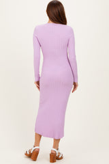 woman wearing a lavender ribbed midi dress, showcasing a fitted silhouette and long sleeves from the back view