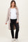 woman wearing a light pink maternity long cardigan over a white top and black jeans, showing her baby bump