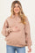 woman wearing a light brown maternity polo sweatshirt and holding her baby bump