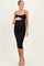 woman wearing a black sparkly maternity dress with spaghetti straps and a visible baby bump