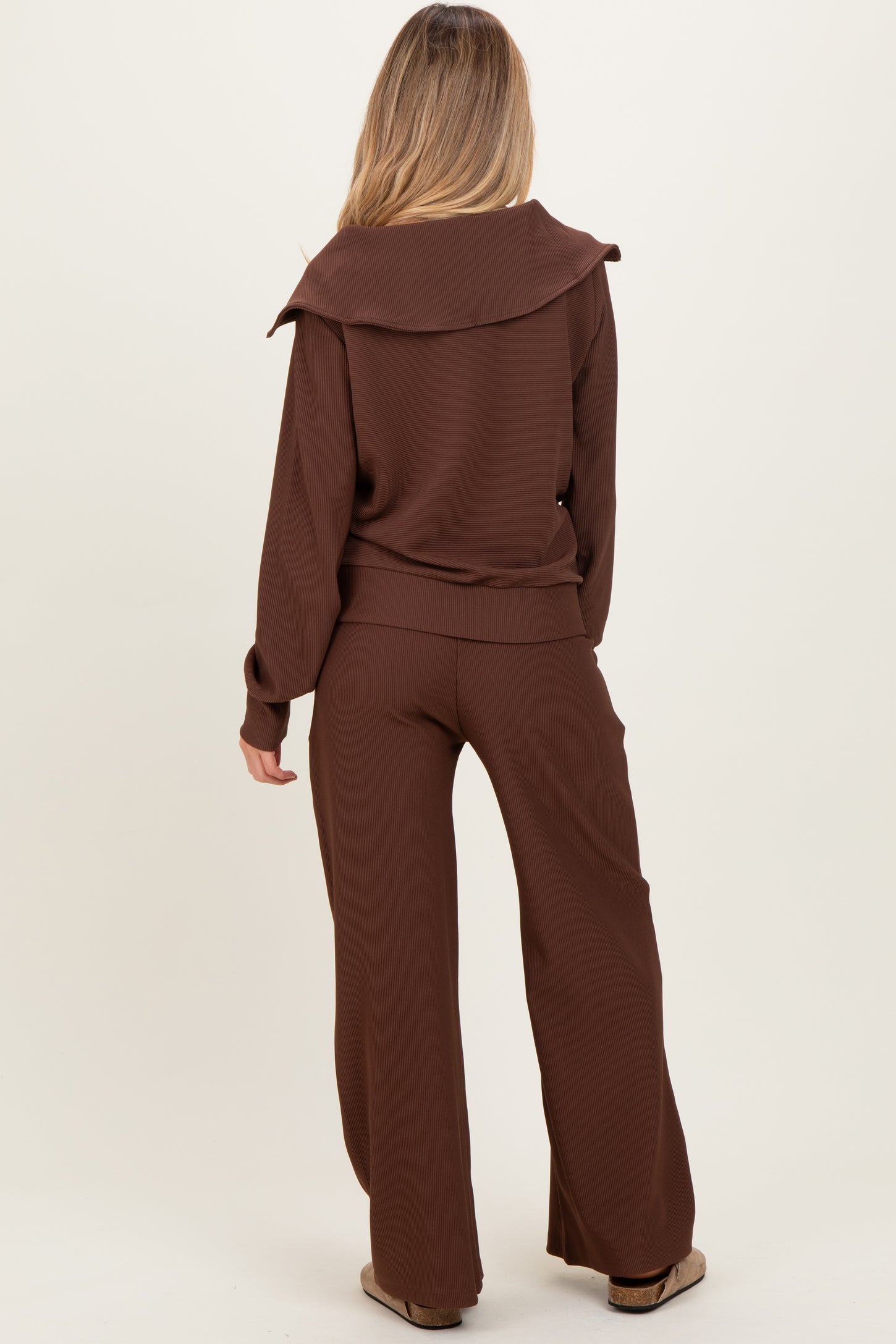 woman wearing a brown maternity ribbed lounge set featuring a wide collar and wide-leg pants