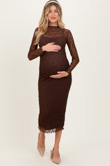 woman wearing a brown lace maternity dress and holding her baby bump