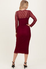 woman wearing a burgundy lace long sleeve midi dress with a fitted silhouette and back view