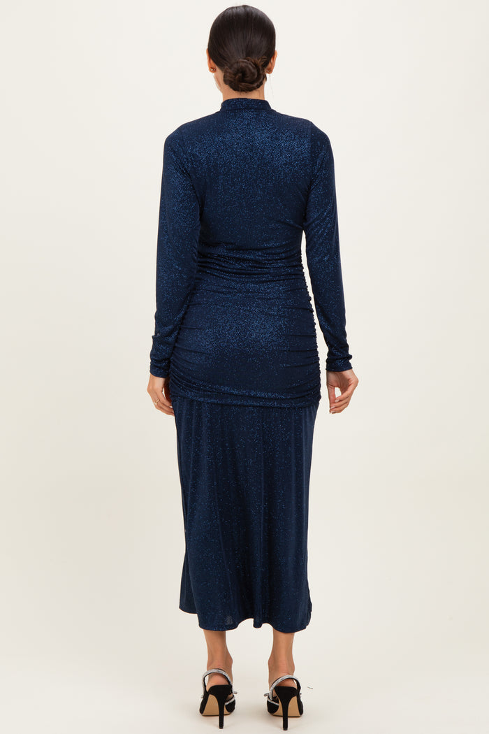 woman wearing a navy blue long sleeve shimmer maxi dress with ruching details and a fitted silhouette