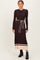 woman wearing a dark brown ribbed long sleeve midi dress with a beige striped hem and a matching belt