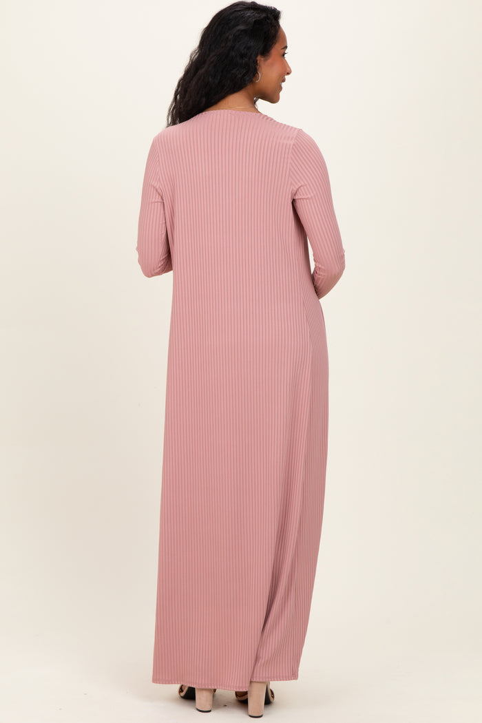 woman wearing a long pink ribbed maternity dress, showing the back view with long sleeves
