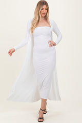 woman wearing a white ribbed midi dress with a long cardigan and strappy black heels