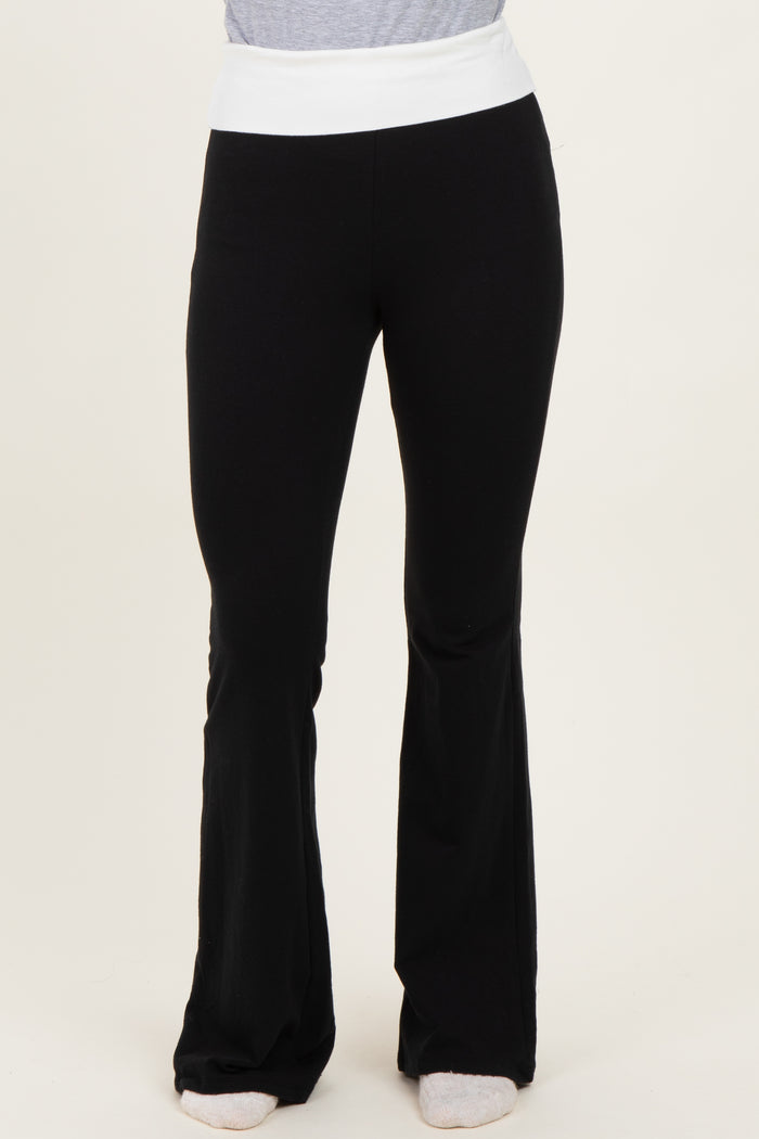woman wearing black flared yoga pants with a white waistband