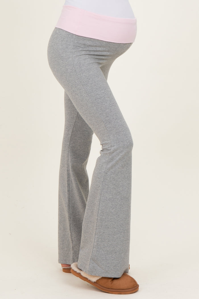 maternity wear gray flared pants with a pink waistband, fitted through the leg and loose at the bottom, baby bump visible