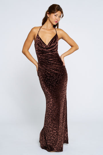 woman wearing a brown leopard print evening gown with a cowl neckline and spaghetti straps