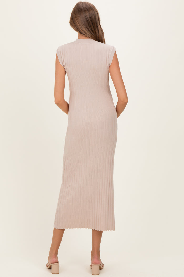 woman wearing a fitted beige sleeveless maternity dress with ribbed texture, shown from the back