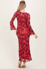 woman wearing a long red floral print dress with bell sleeves and a keyhole back detail