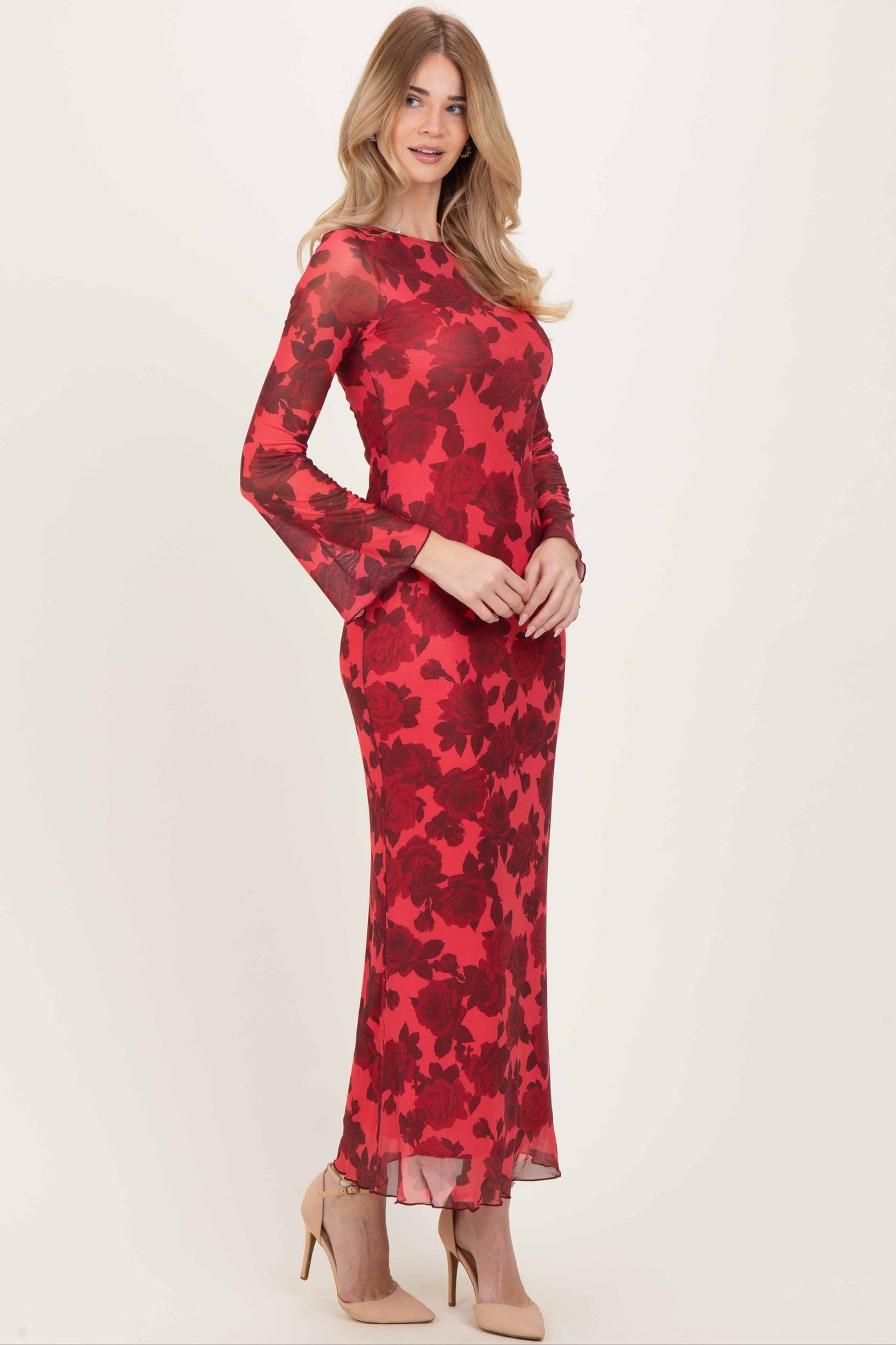 woman wearing a red floral long sleeve maxi dress with bell sleeves and a fitted silhouette