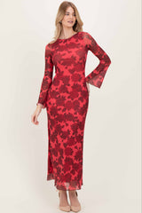 woman wearing a red floral long sleeve maxi dress with bell sleeves and a side slit