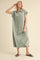 woman wearing a light green short sleeve maxi dress with a collared neckline and relaxed fit