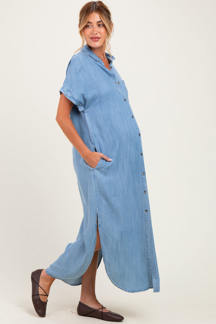 woman wearing a light blue button-up maternity dress with short sleeves and side slits, showcasing her baby bump