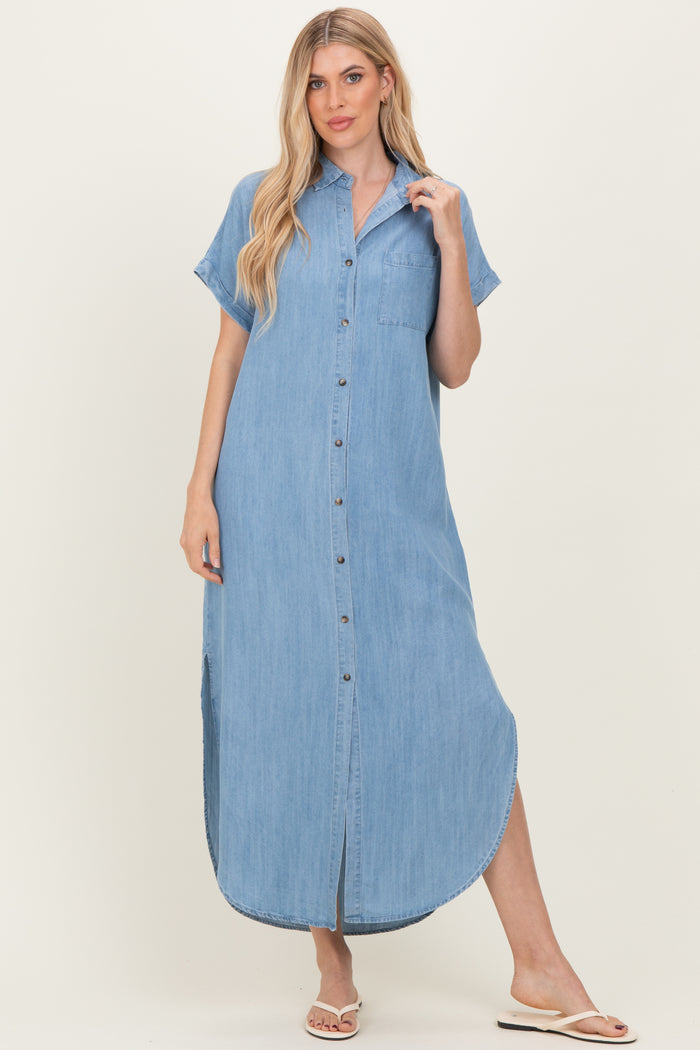 woman wearing a light blue denim shirt dress with short sleeves and buttons down the front