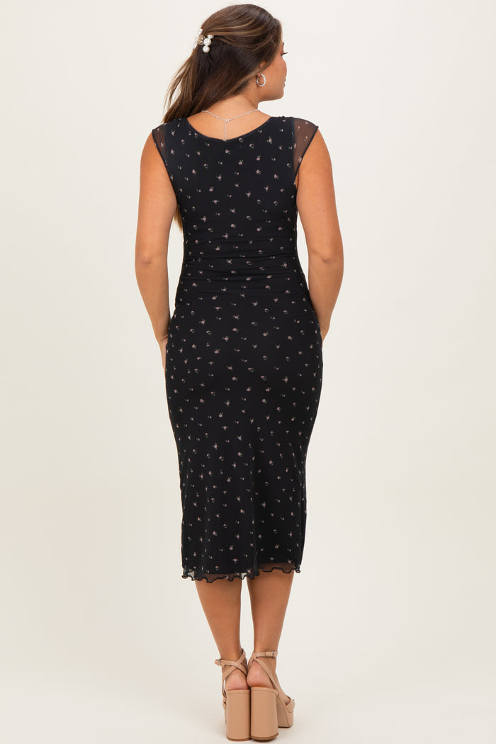 woman wearing a black maternity dress with floral print and a fitted silhouette, seen from the back