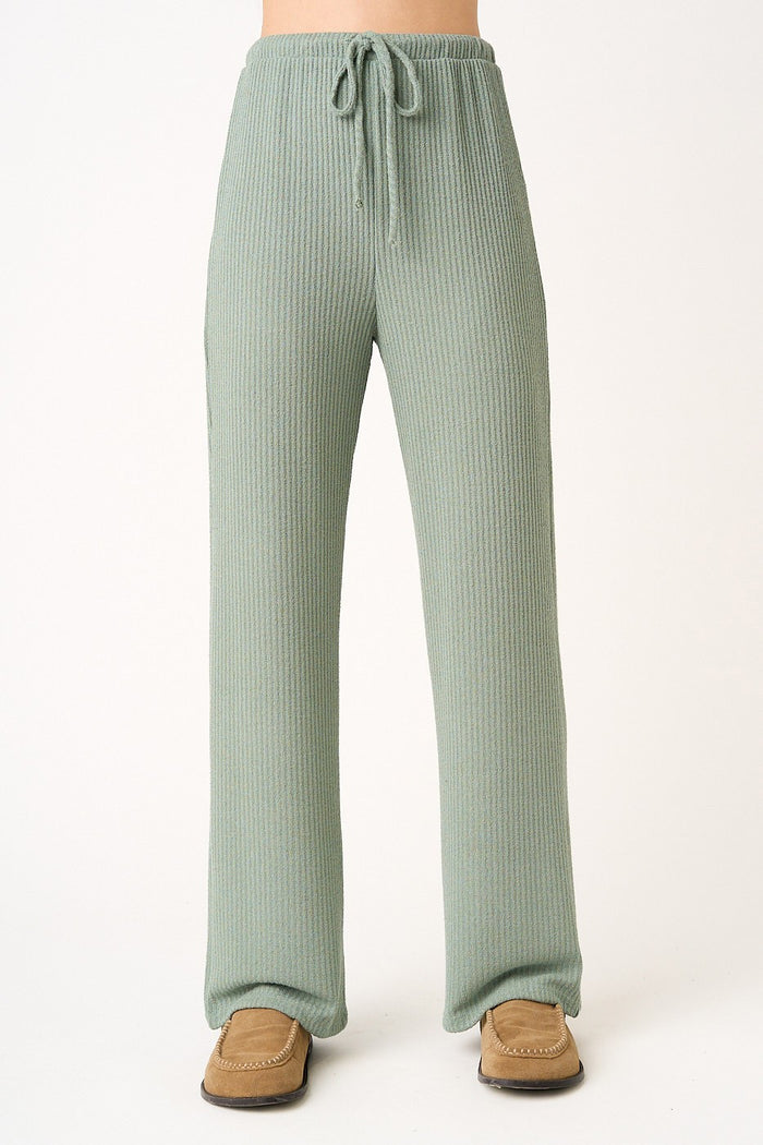 woman wearing light green ribbed wide-leg pants with an adjustable drawstring waistband