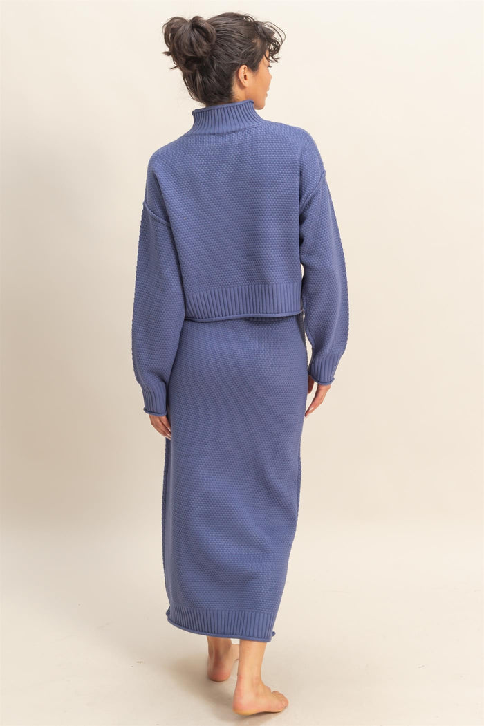woman wearing a cozy blue knit two-piece set with a cropped sweater and long skirt, seen from the back